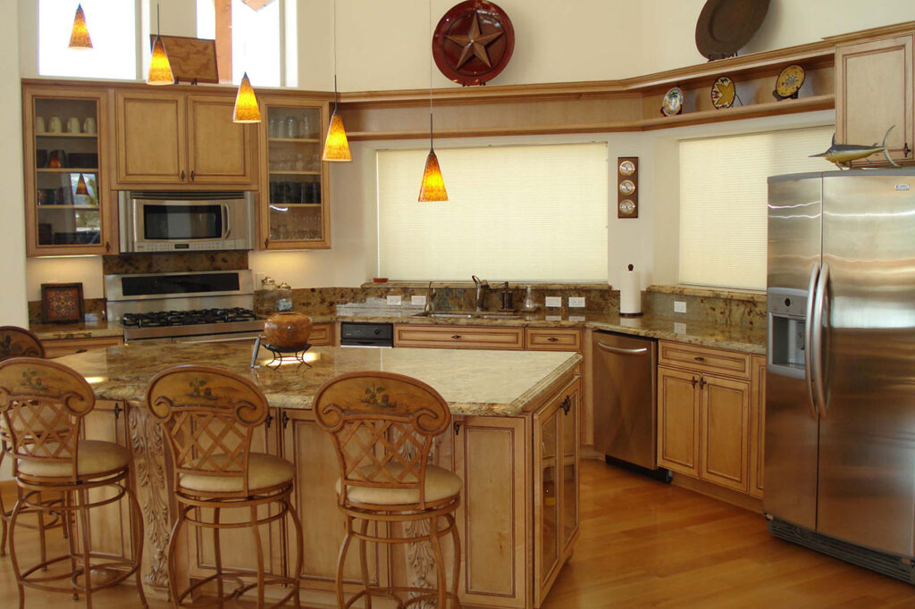 KITCHEN WITH SOLID GRANITE COUNTERTOPS, DECORATIVE CABINET DOORS, AND STAINLESS STEEL APPLIANCES