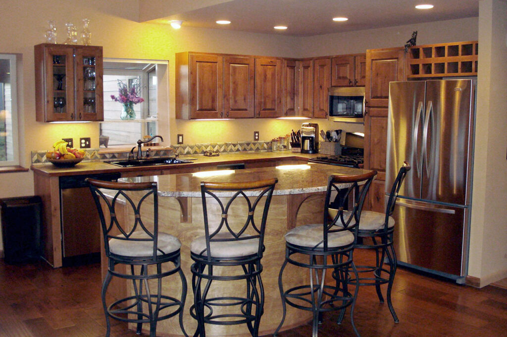 KITCHEN WITH CUSTOM BAR, AND STAINLESS STEEL APPLIANCES