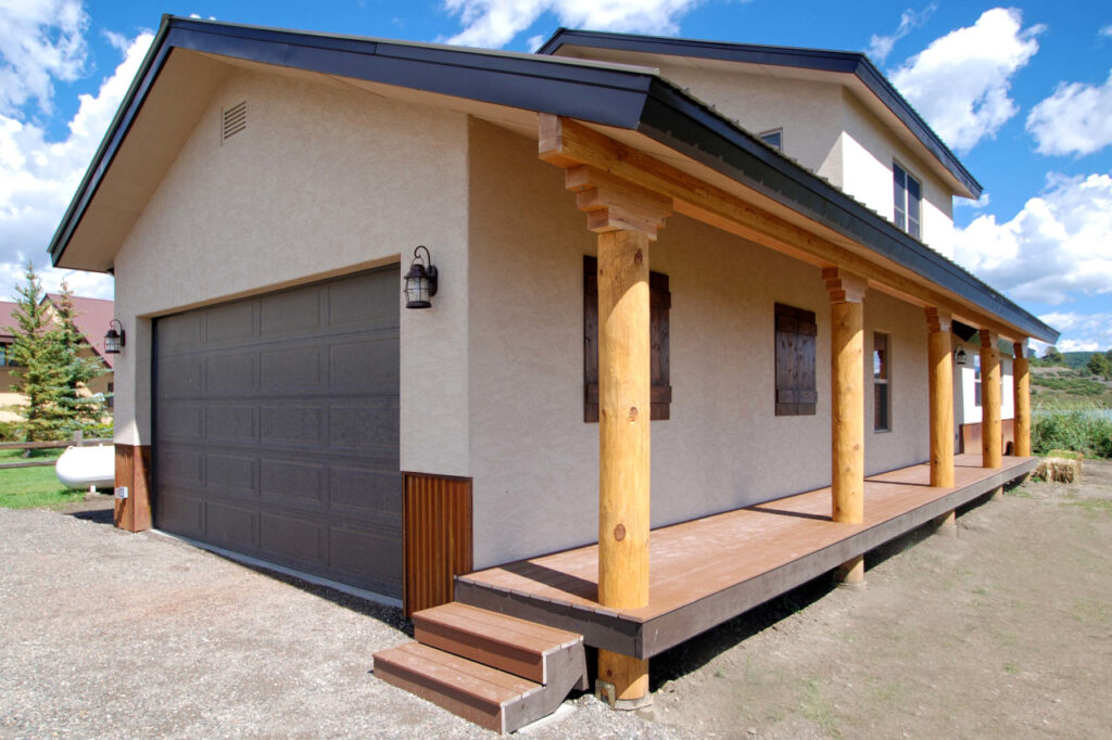 MODIFIED GARNET WITH STUCCO EXTERIOR AND LOG POSTS